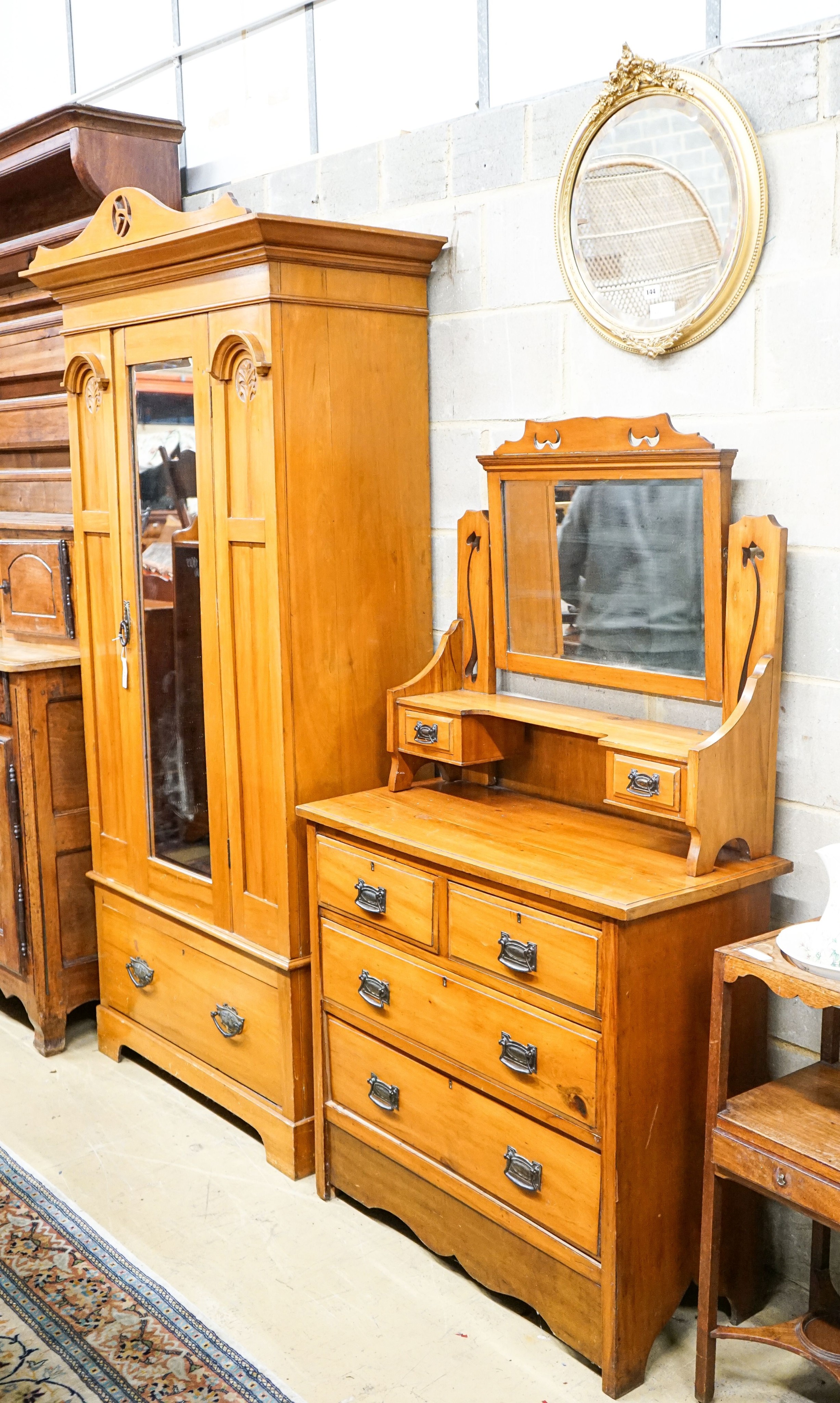 A late Victorian satin walnut mirrored wardrobe, length 105cm, depth 48cm, height 210cm and a dressing table